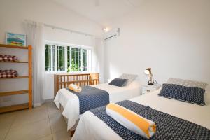 a bedroom with two beds and a window at Villa Philibert in Riambel +49 photos