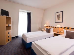 Voodi või voodid majutusasutuse ACHAT Hotel Dresden Elbufer toas