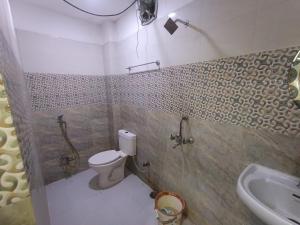 a bathroom with a toilet and a sink at Hotel Jagdamba Residency in Chupra