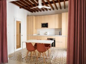 a kitchen with a white table and chairs at Casa Soleá- a dos min de la playa in Castell de Ferro