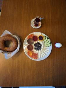 a table with a plate of food and a bagel at Heraldic Room Hotel in Esenyurt