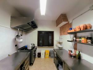 a kitchen with stainless steel counter tops in a kitchen at Rifugio lo Schioppo in Morino
