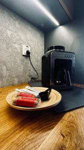 a toaster sitting on top of a table with a plate at Loft No 35 Premium Apartment in Głogów