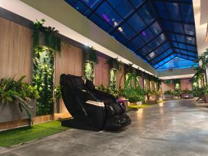 a hallway with plants on the walls of a building at Modern Palace Dawassah in Al Mawşil