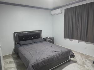 a bedroom with a large bed and a window at New Modern Apartment in Willemstad