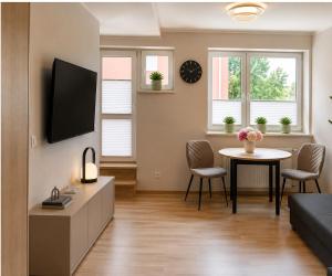 a living room with a couch and a table at Kaszmirowy Apartament in Wałcz
