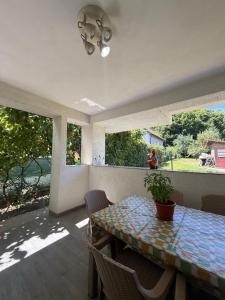 a dining room with a table and chairs and windows at Vila MaeStar in Curtea de Argeş