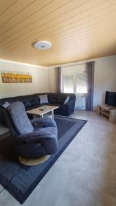 a living room with a couch and a table at Ferienwohnung Römerweinhof in Neumagen-Dhron
