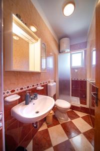 a bathroom with a sink and a toilet at Marin in Lopar