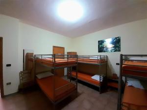 a room with three bunk beds and a light on the ceiling at Rifugio lo Schioppo in Morino