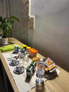 a table with food and bottles of water on it at Piazza San Giorgio B&B in Serrano