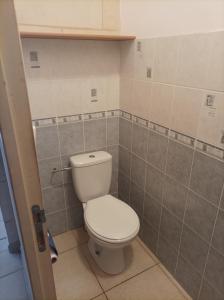 a bathroom with a white toilet in a room at Les 2 Chênes in Saumur