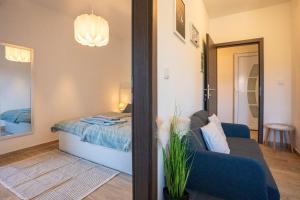 a room with a bed and a couch and a mirror at Marin in Lopar