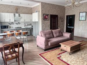a living room with a couch and a table at Halal House Vip in Qusar