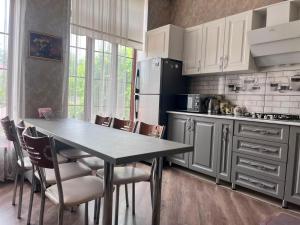 a kitchen with a table and chairs and a refrigerator at Halal House Vip in Qusar +18 photos