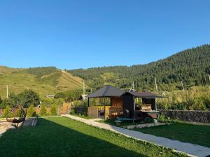 a garden with a gazebo in the middle of a yard at Miman house Kolsay in Kurmenty