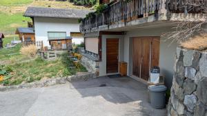 a house with a toilet sitting outside of it at Petit studio à Lourtier in Lourtier