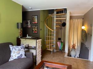 a living room with a couch and a fire place at Casa Vacanza Pigna in Pigna