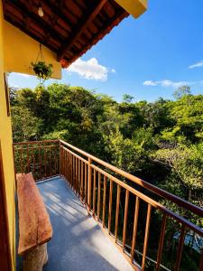 a balcony of a house with a view of trees at Reserva do Bosque Hospedaria e Natureza in Ibicoara