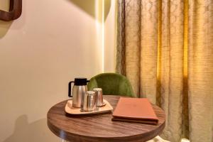 a wooden table with a coffee pot on top of it at Hotel Bhagyalaxmi NX in Shirdi