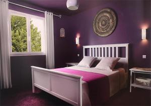 a purple bedroom with a bed and a window at La perle rouge A Panazol in Panazol