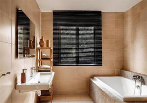 a bathroom with a white tub and a sink at La perle rouge A Panazol in Panazol +29 photos
