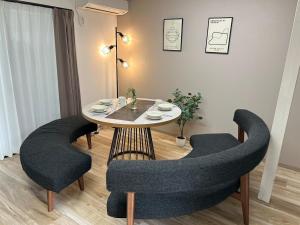 a dining room with a table and two chairs at koharubi hanada in Murochō