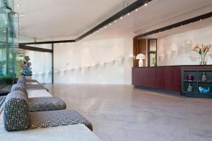 a lobby with a row of seats in a building at Four Points by Sheraton Catania Hotel in Catania