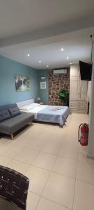 a bedroom with two beds and a stone wall at Villa Sotiriou in Límni