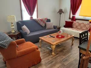 a living room with a blue couch and a coffee table at Simple Stay in Youngstown