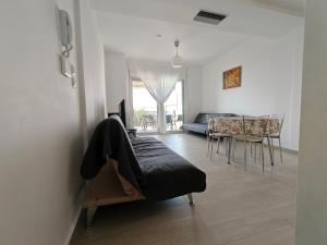 a living room with a couch and a table at Апартаменты Елена in Nea Peramos