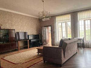 a living room with a couch and a television at Halal House Vip in Qusar