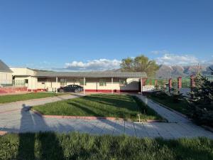 a house with a lawn and a driveway at Ayara home in Kyzart