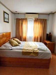 a bedroom with a large bed with a window at Dream Garden Hotel in Solano