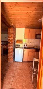 a kitchen with a white refrigerator and a brick wall at u Vlastika in Jeseník