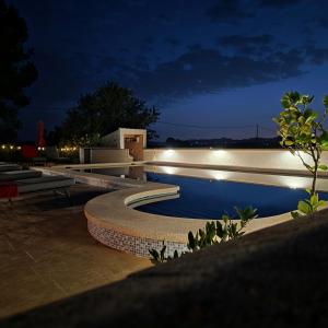 a swimming pool at night with lights on it at Casa de las Murallas, Bed&Breakfast in Yecla