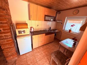 a small kitchen with a white refrigerator and a table at u Vlastika in Jeseník