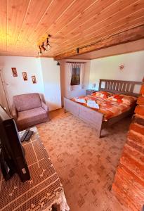 a bedroom with a bed and a chair in it at u Vlastika in Jeseník