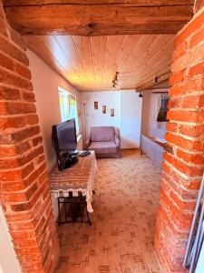 a living room with a couch and a television on a table at u Vlastika in Jeseník +11 photos