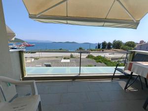 a balcony with a view of a swimming pool at Апартаменты Елена in Nea Peramos