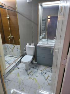 a bathroom with a toilet and a sink at Mamura Karimova in Andizhan +3 photos