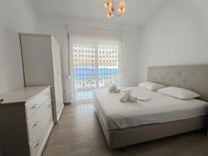 a bedroom with a bed and a dresser and a window at Апартаменты Елена in Nea Peramos