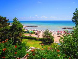 a beach with a bunch of umbrellas and the ocean at Casa Rodica in Mangalia