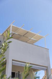 awning on the side of a white building at Apartments 2A in Petrcane +34 photos