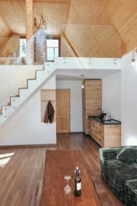 a living room with a staircase and a couch at Chalets by Hotel Transalpin in Obarsia-Lotrului +15 photos