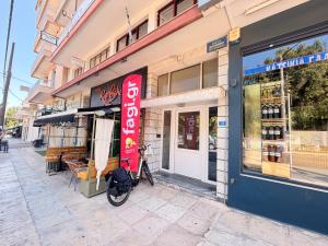 a bike parked outside of a store on a street at Central Park Chíos in Chios