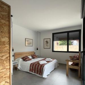 a bedroom with a bed and a window at Los Castaños in La Alberca