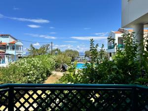 a view of a pool from a balcony at Aegean Sun Hotel in Skala Rachoniou