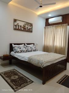a bedroom with a bed and a window at Wale's Hilltop Villa in Kolhapur