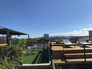 a patio with chairs and tables on a roof at Vivaldi Suites in Villa Carlos Paz +70 photos
